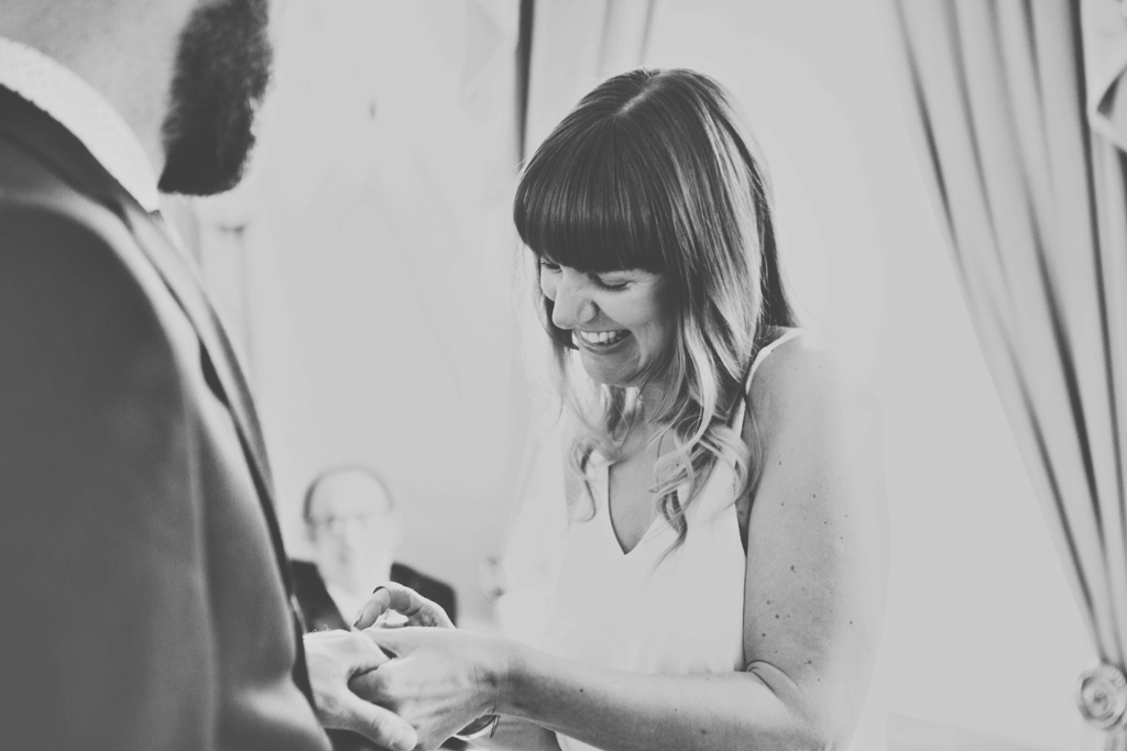 Giggling bride during ring exchange Milldam House Portsmouth 
