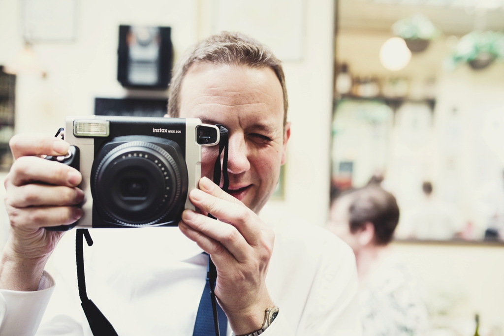 Man with polaroid camera Portsmouth wedding 