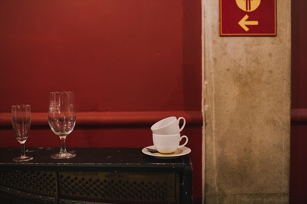 Empty glasses and coffee cups at the end of a wedding at Battersea Arts Centre by Lisa Jane Photography