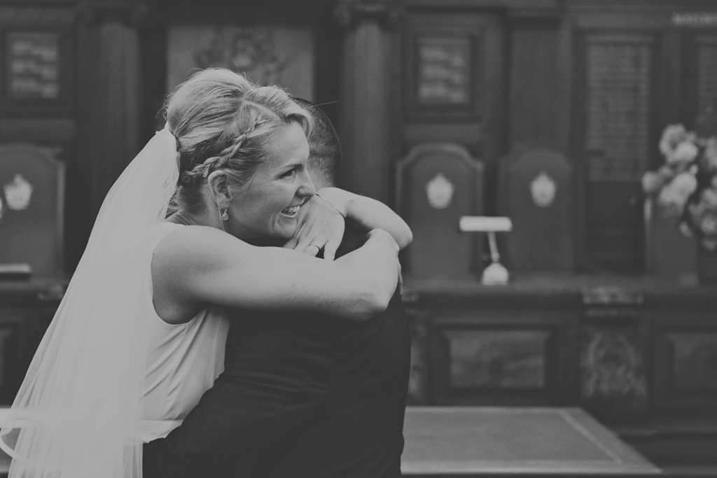 Bride hugs groom Islington Town Hall wedding venue London