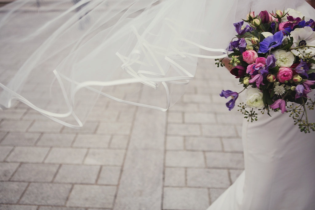 Creative wedding portrait with bridal veil and bouquet London