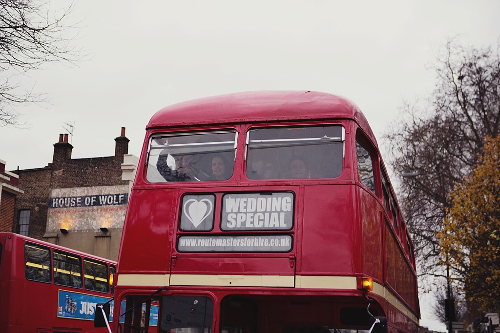 Red routemaster London bus transporting wedding guests