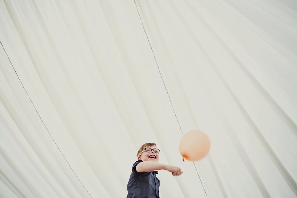 Cute boy with balloon at Derby wedding