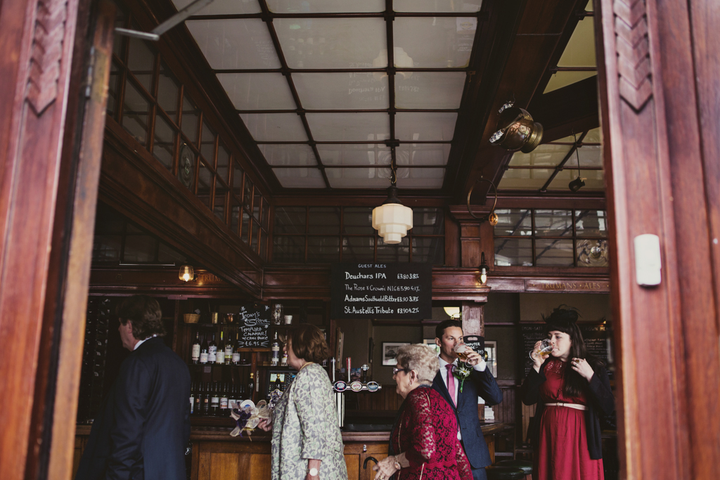 weddings guests in a pub by Lisa Jane Photography