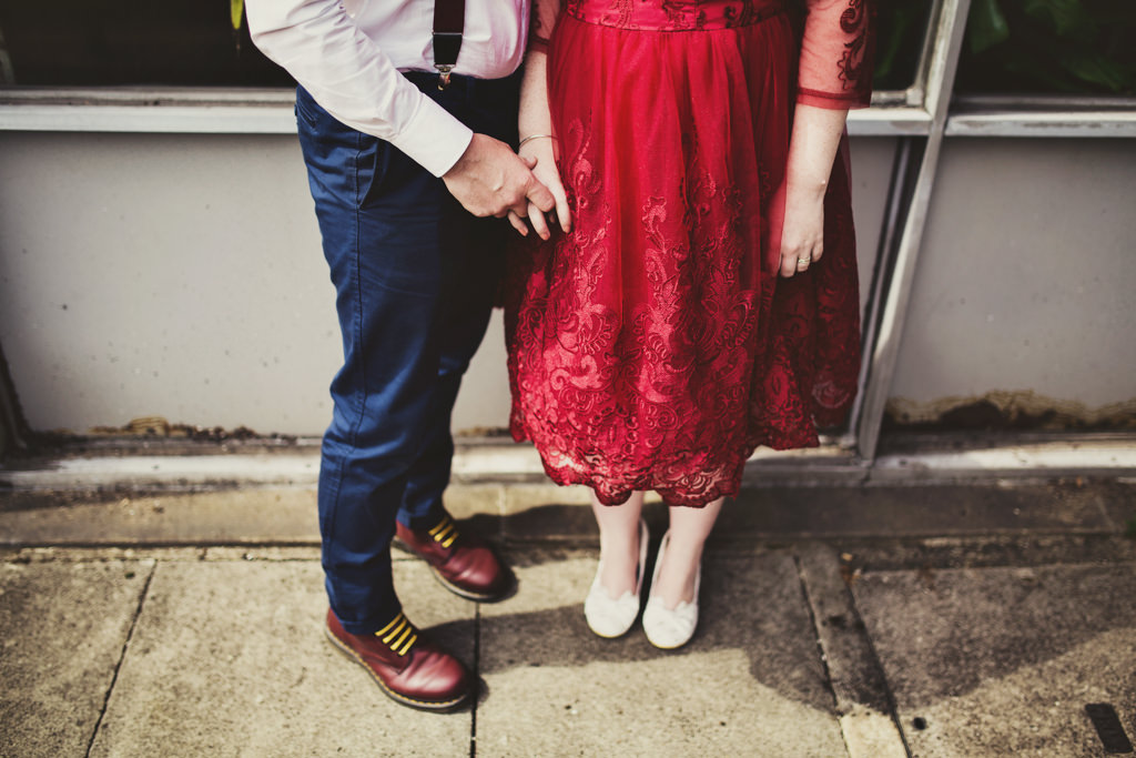 Quirky wedding portrait bride with groom shoes Elopement wedding photography London