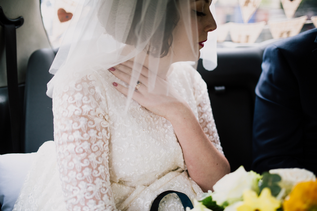 bride in black cab by Brighton pub wedding photography Lisa Jane Photography