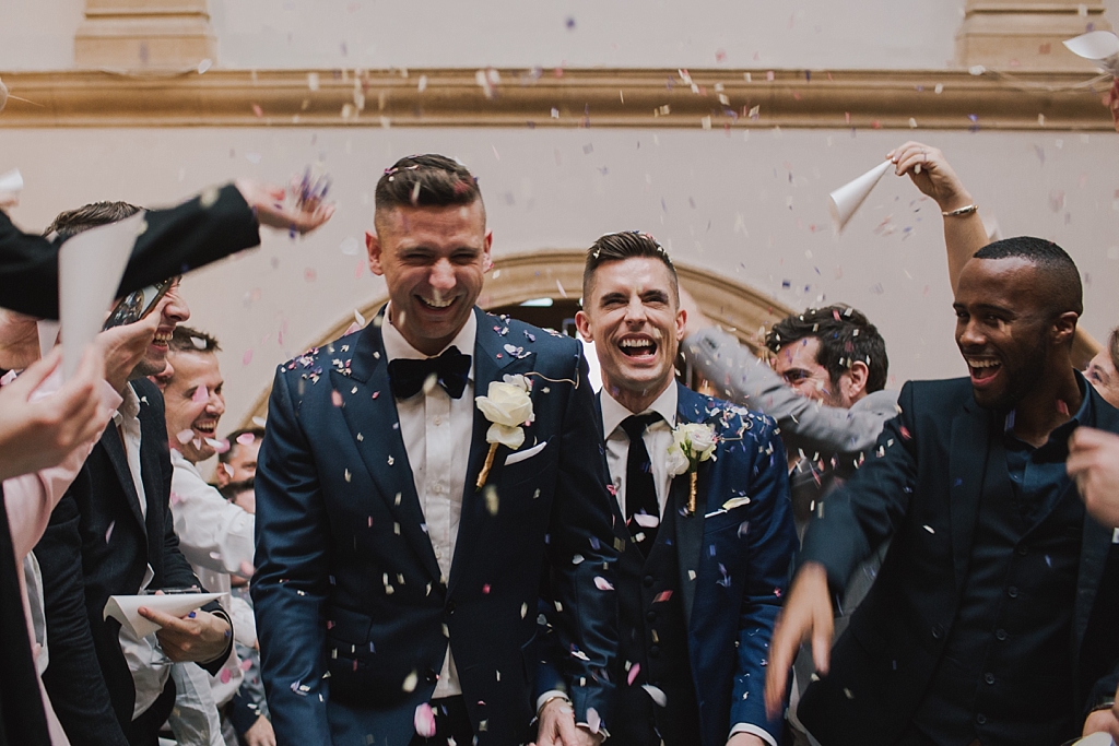 Two grooms showered with confetti at a Battersea ARts Centre Wedding by Lisa Jane Photography