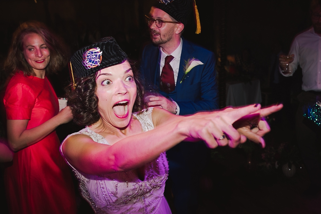 Bride on the dance floor in a custom made fez | Wiltons Music Hall Wedding Photographer | Lisa Jane Photography