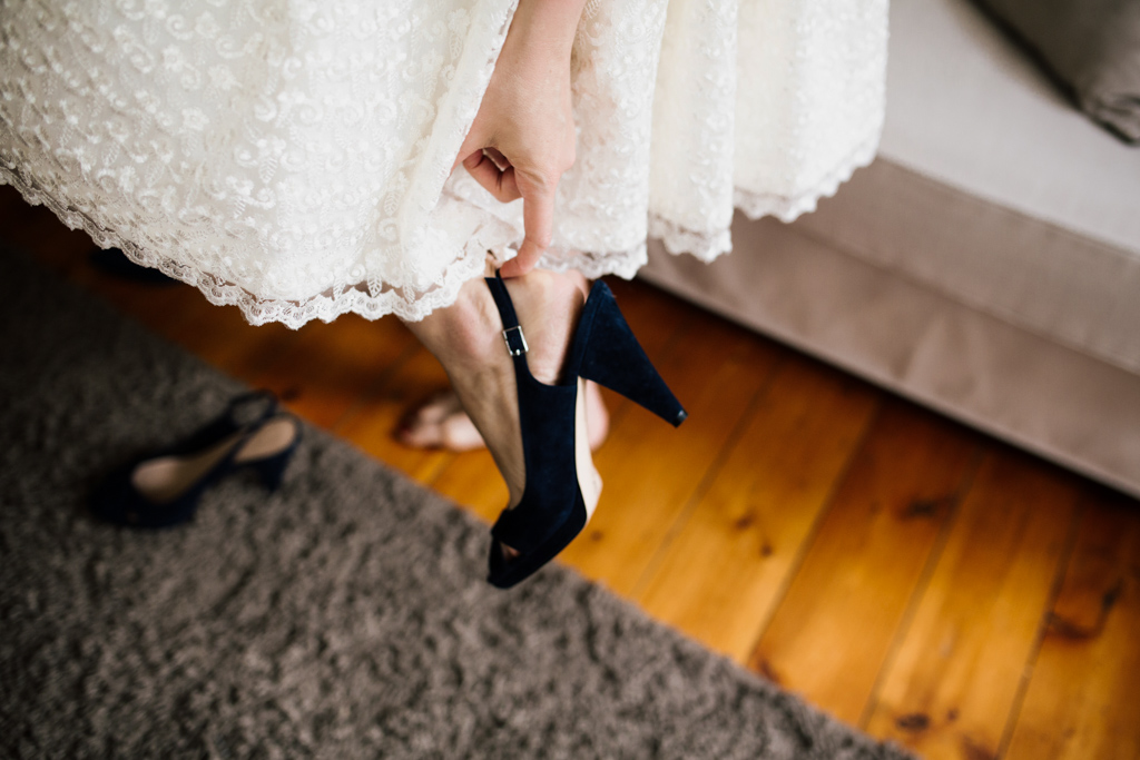Bride putting on shoes at a Brighton Town Hall Wedding | Lisa Jane Photography | Alternative UK Wedding Photography