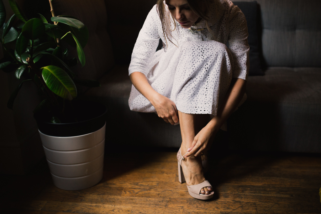 Bride putting on her shoes at a London Elopement | Lisa Jane Photography | Creative London Wedding Photography