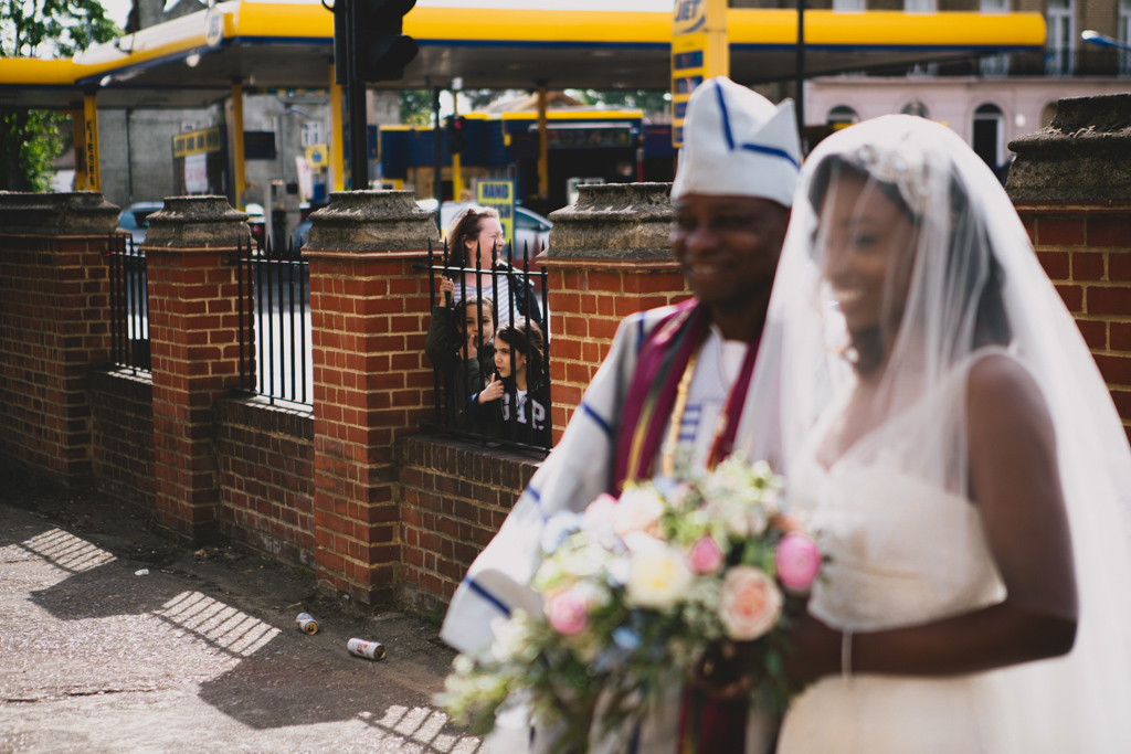 Kids watching at bride walks into her church wedding | Lisa Jane Photography | Modern Documentary London Wedding Photography