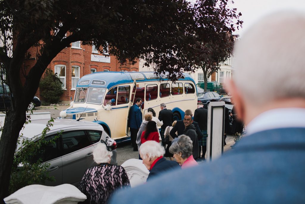 Guests getting on vintage wedding bus at Southend wedding | Lisa Jane Photography | Creative London Wedding Photography