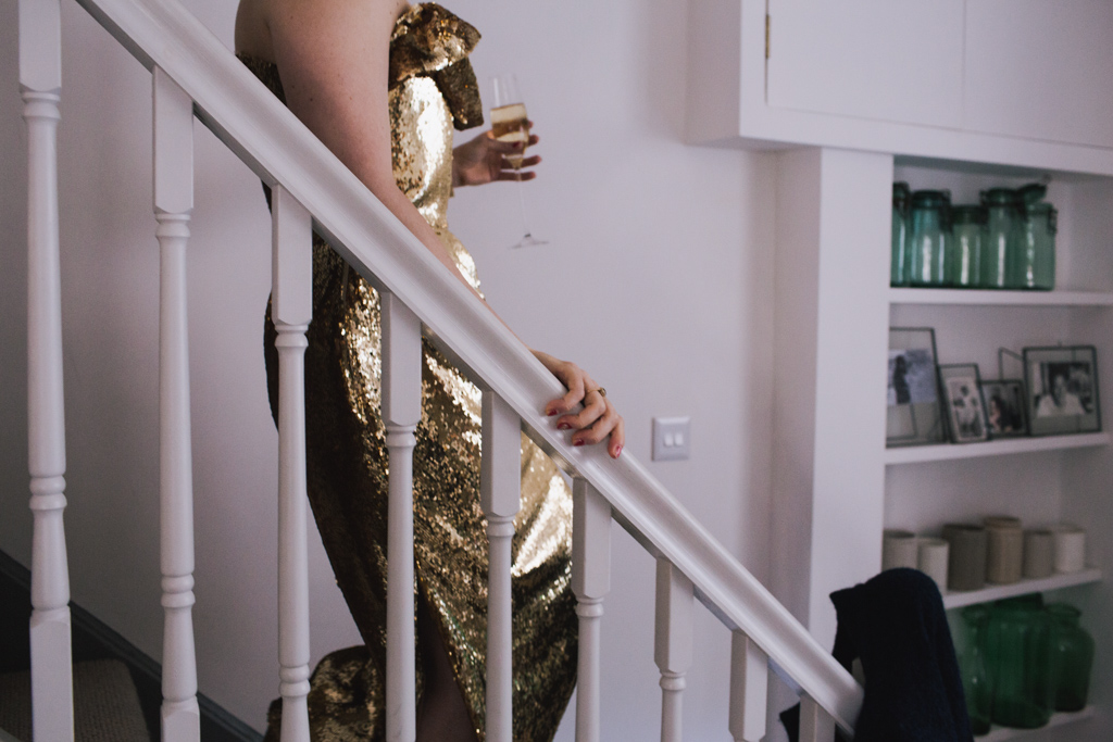 Bride in bespoke gold dress walking down stairs to a london first look | Lisa Jane Photography | Modern London Wedding Photography