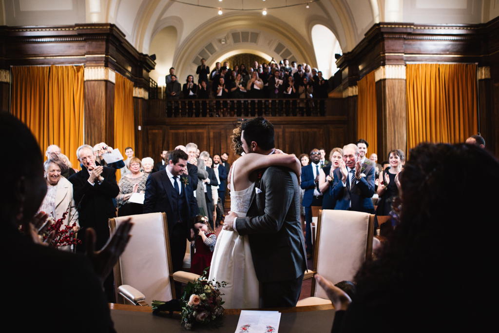 Bride and groom huging at Stoke Newington Town Hall wedding | Lisa Jane Photography | Modern London Wedding Photography