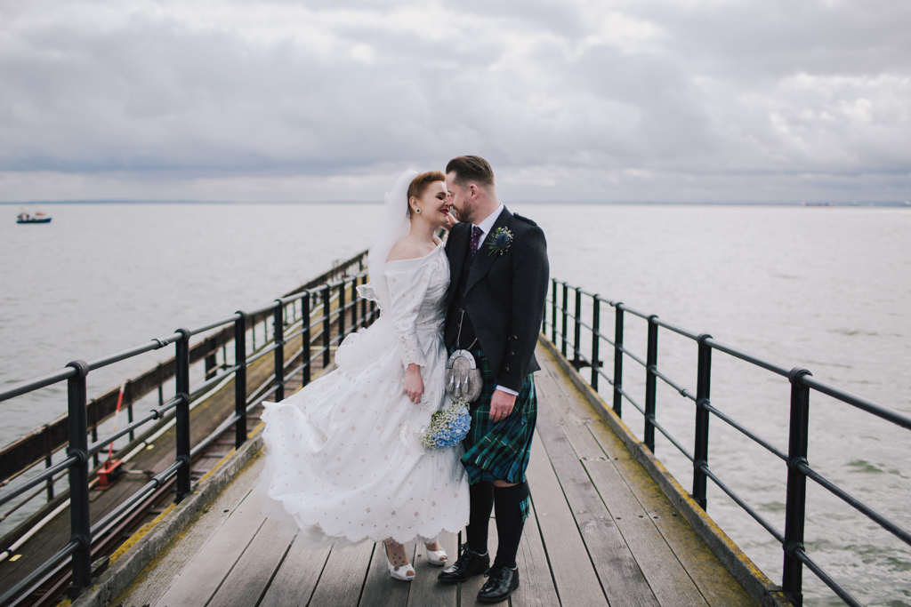 Couple hugging on Southend pier | Lisa Jane Photography | Modern London Wedding Photography