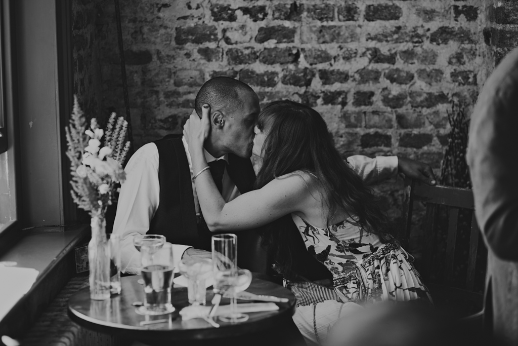 moment between two guests at Wiltons Music Hall | Creative Modern London Wedding Photography
