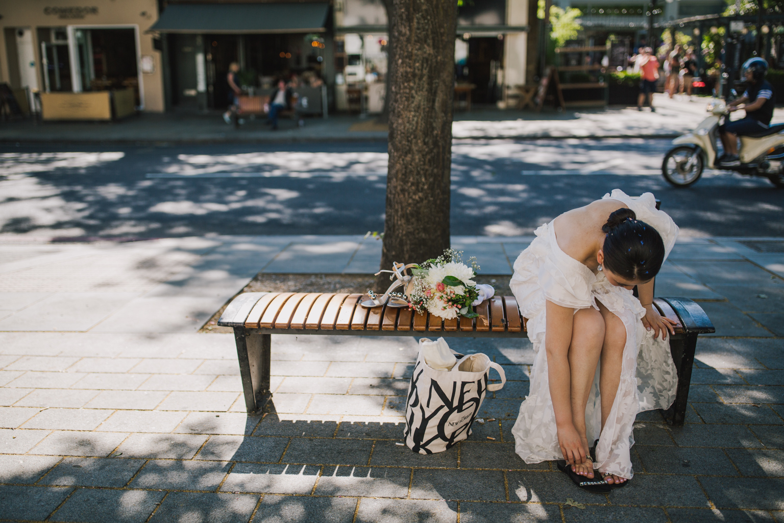 Bride changing shoes outside Islington Town Hall by Lisa Jane Photography
