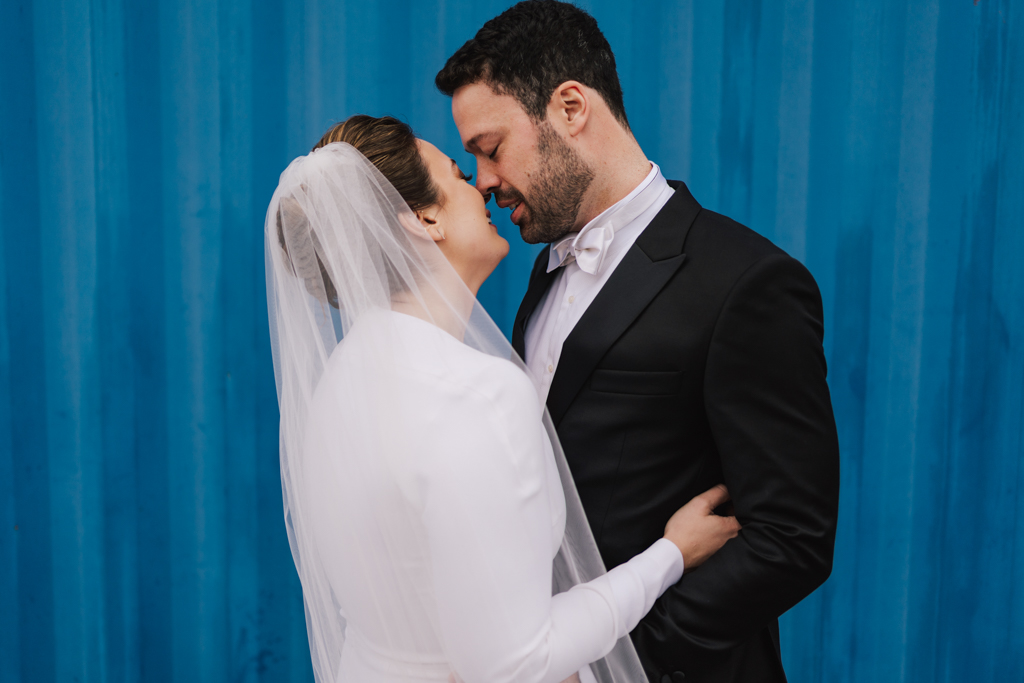 Bride and groom first kiss at a Electrcians Shop Wedding by Lisa Jane Photography